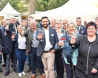 Gute Stimmung in der Wassermühlenstraße: Vertreter der Interessengemeinschaft Handel und Gewerbe Uetersen, aus der Politik und von der Unteroffizierschule der Luftwaffe in Appen erhoben zur Eröffnung des Weinfestes ihre Gläser. (Foto: Frank)